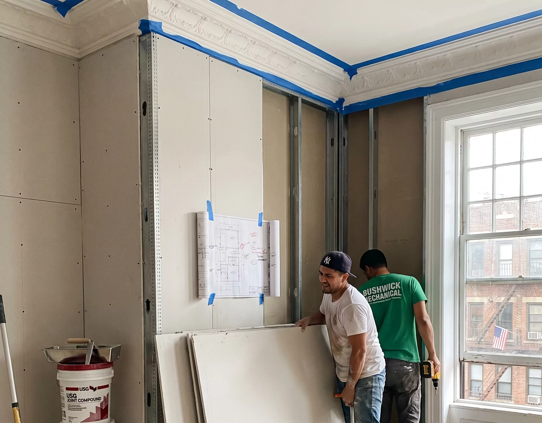 New drywall going up against the original pre-war crown molding inside the PINEHURST 8B living room